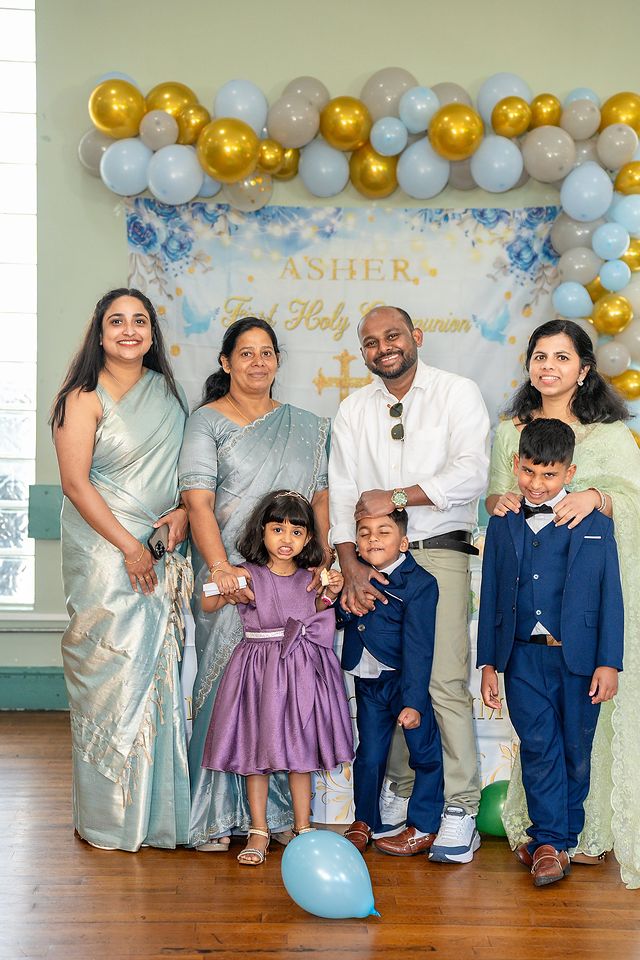 Family celebrating a First Holy Communion at home with balloons