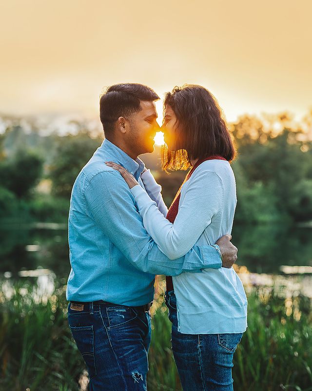 Couple kissing at sunset