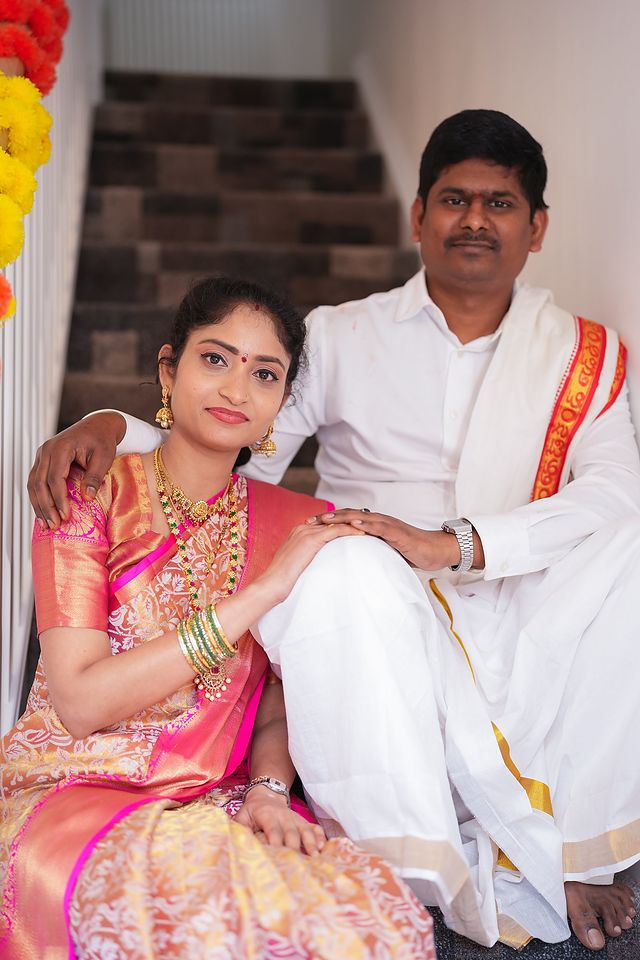 Couple in traditional dress at their housewarming