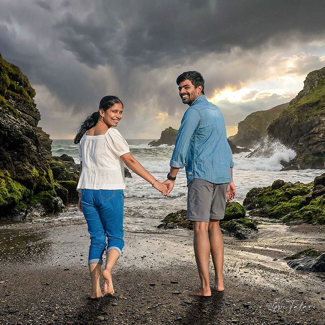 Couple walking on a stormy beach