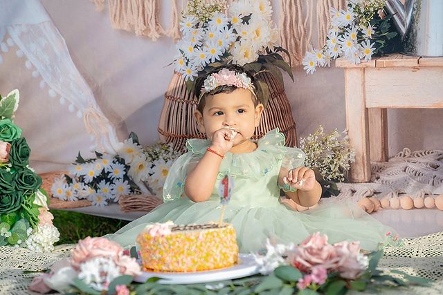 Baby with her first birthday cake