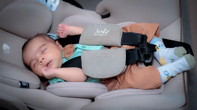 Sleeping newborn in car seat