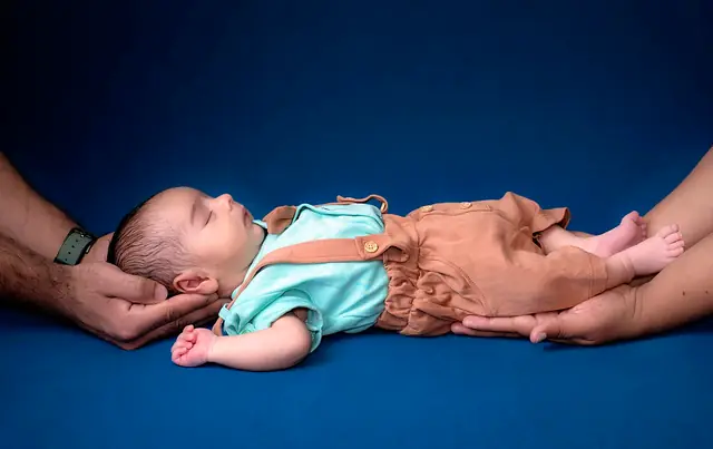 Newborn held in parents' hands