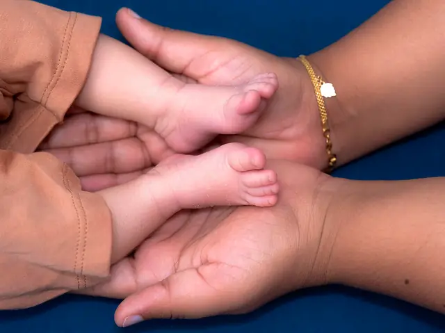 Newborn feet in parents' hands