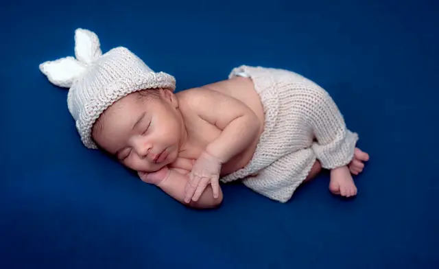 Newborn in knitted bunny bonnet