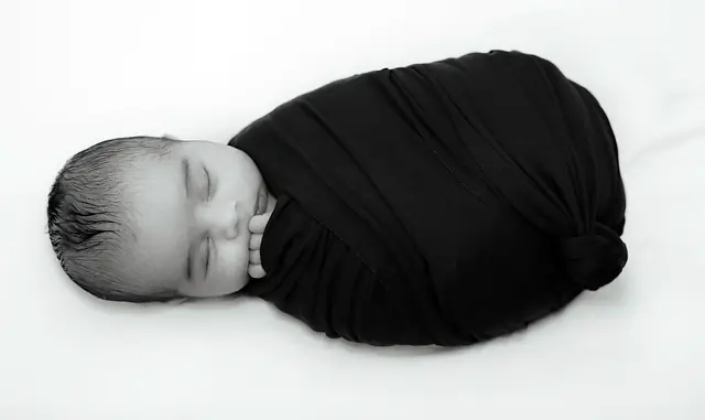 Black and white wrapped newborn