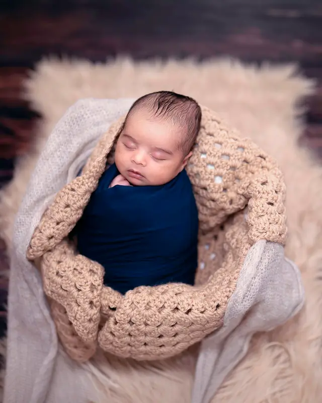 Newborn in knitted nest
