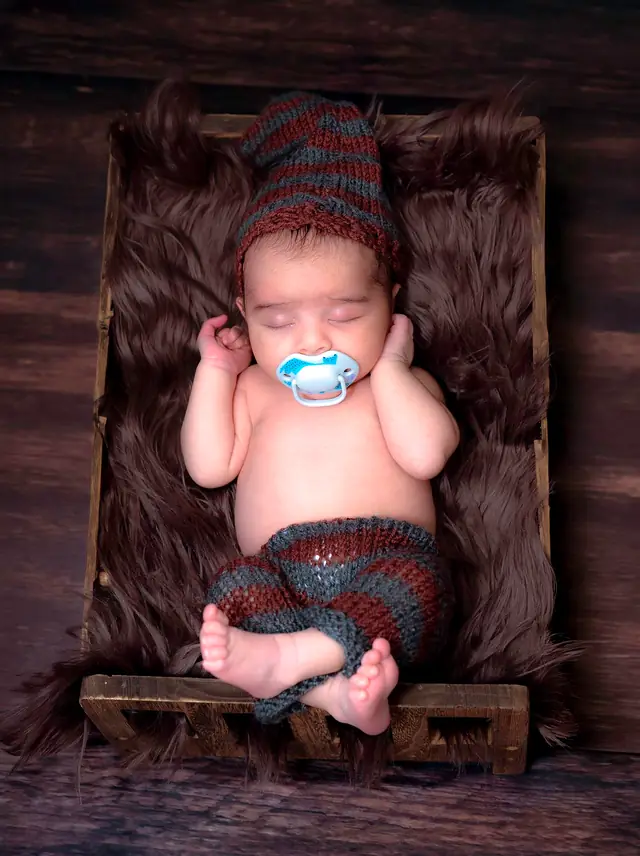 Newborn in wooden crate prop