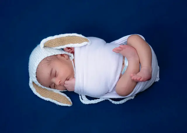 Newborn in bunny-ear wrap