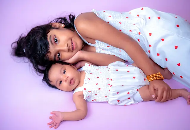Sisters on lilac backdrop