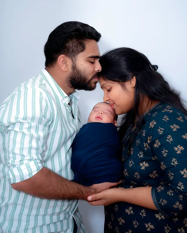 Parents with newborn, family portrait