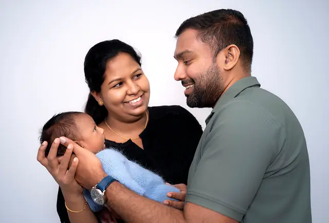 Parents smiling with their newborn