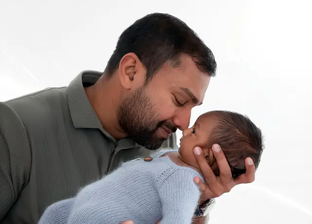 Father with newborn, soft light