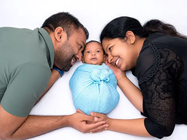 Parents with newborn in blue wrap