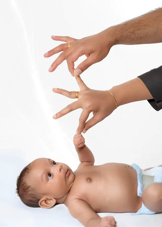Parents' hands with newborn
